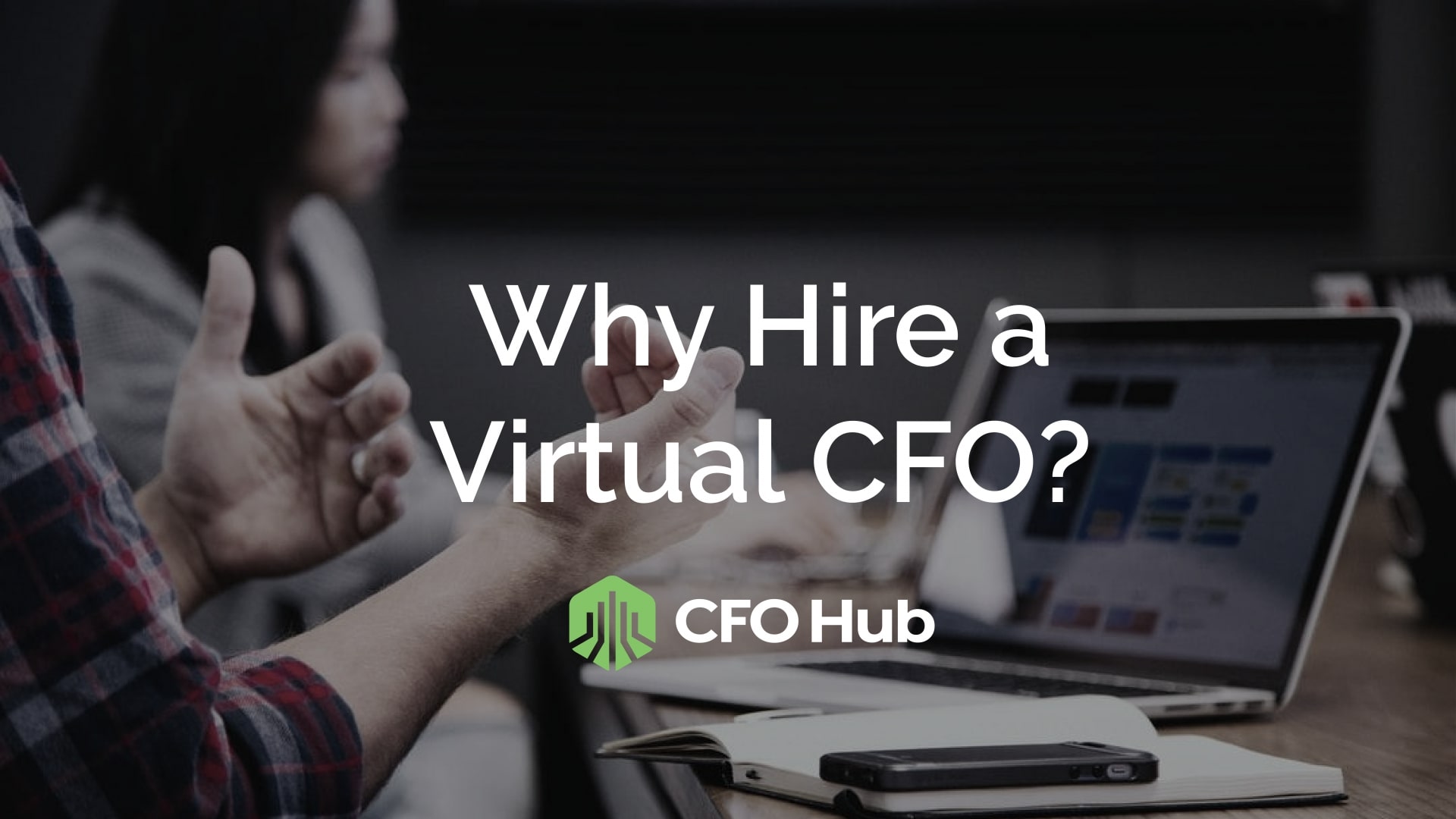 A presentation is underway in a conference room, highlighting the text "Why Hire a Virtual CFO?" prominently on the screen. Beneath the text, the "CFO Hub" logo is visible. Attendees are seated at a table with laptops and devices, poised to learn about the benefits of hiring a Virtual CFO.