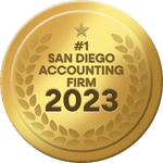 A gold badge with a star at the top and laurel leaves along the sides. The text in the center reads, "#1 San Diego Accounting Firm 2023".