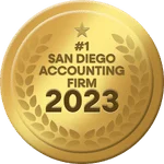 A gold medal with a star at the top and the text "#1 San Diego Accounting Firm 2023" in the center. The medal is surrounded by a laurel wreath design.