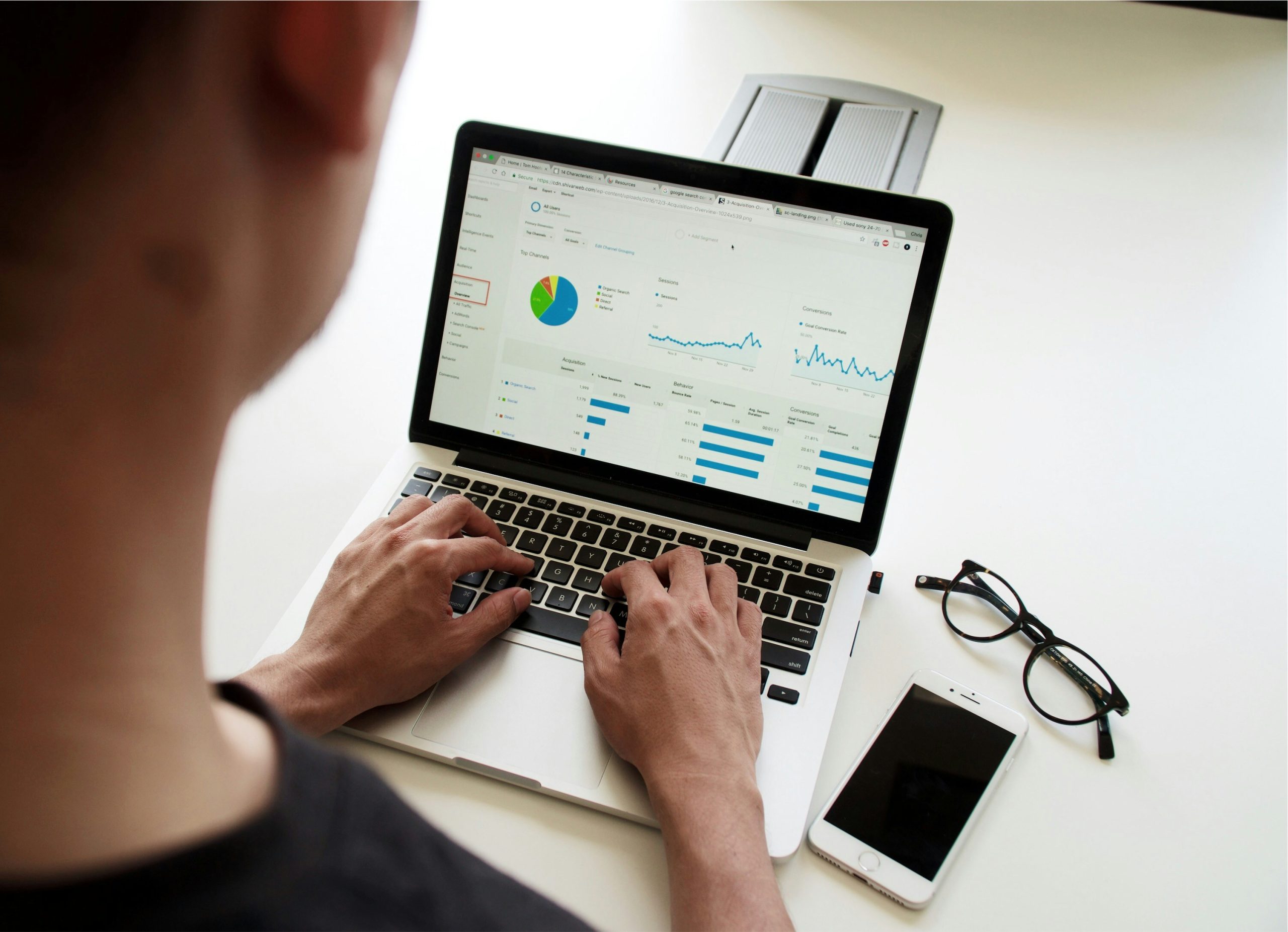 Man on laptop looking at a financial reporting dashboard