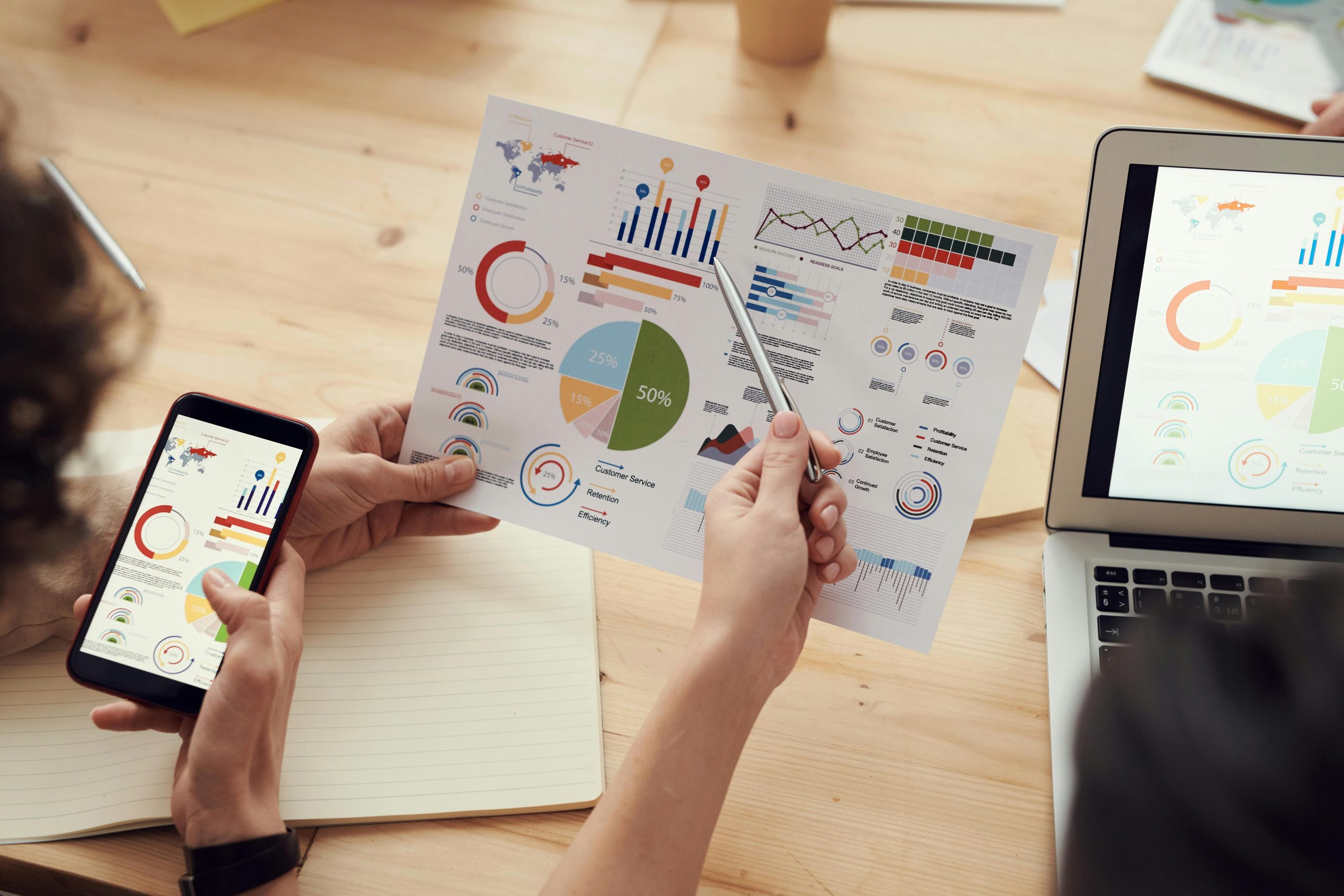Two people looking at financial documents and reports